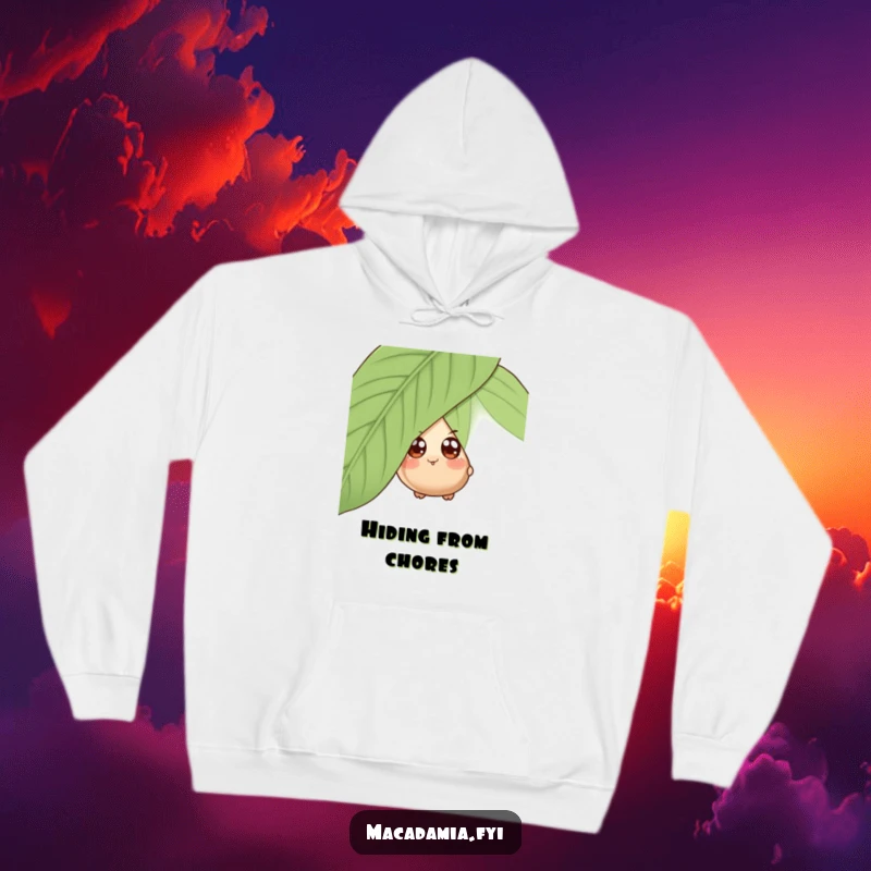 Funny hoodie with a wide-eyed macadamia nut character playfully peeking from behind a giant leaf, offering cozy mystery.