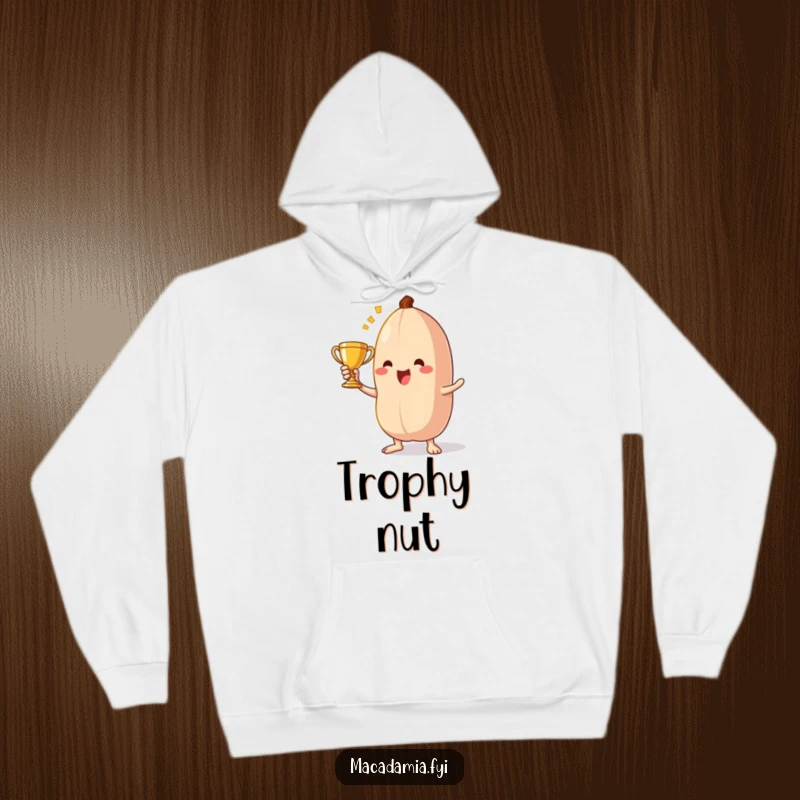 Funny macadamia nut hoodie art depicting a triumphant character holding a tiny trophy, celebrating a nutty achievement.