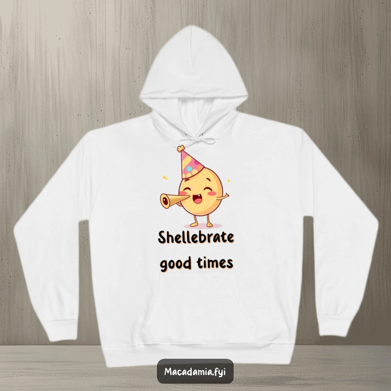 Funny hoodie with a macadamia nut character in a party hat, excitedly blowing a party horn, bringing cozy celebration energy.