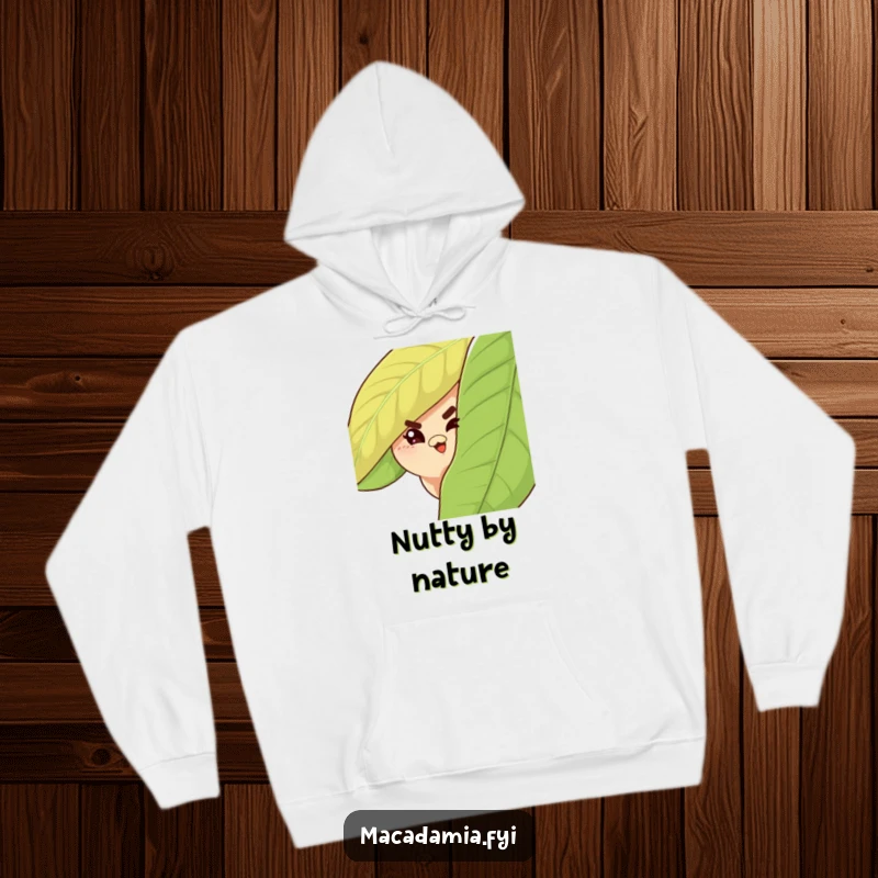 Funny Macadamia Nut Hoodie featuring a sly nut peeking from behind a leaf, giving a mischievous wink.