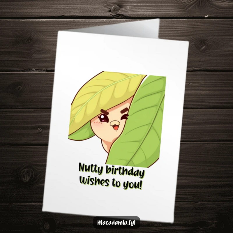 Funny Free Printable Macadamia Nut Birthday Card: A cheeky nut peeking from behind a leaf with a mischievous wink.